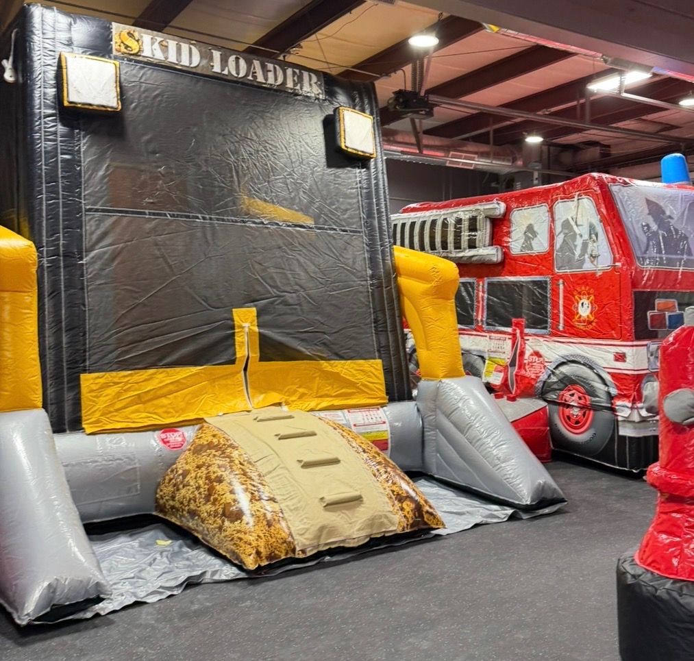 Skid Loader bounce house and fire truck inflatable at The Kids Garage